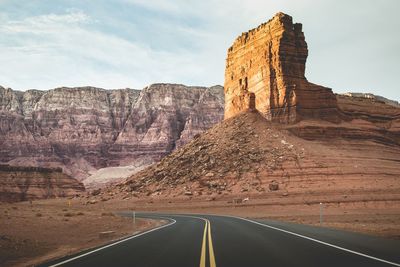 Road leading towards rocky mountains