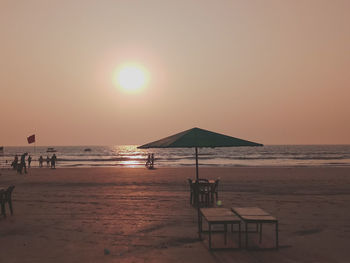 Scenic view of beach against sky during sunset