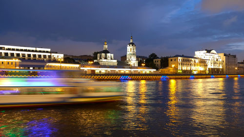 River cruise ship sails along the moscow river, night city, movement by incorporating a motion blur.