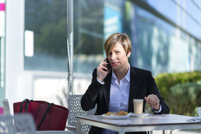 Young businesswoman using laptop at office