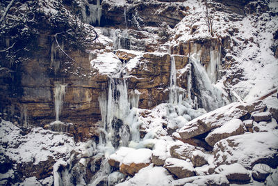 View of frozen waterfall on rocks