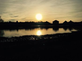 Scenic view of lake against sky during sunset