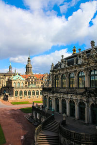 Buildings in city against cloudy sky