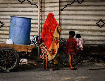 Rear view of woman standing on street