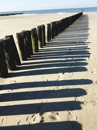 Surface level of walkway by sea against sky