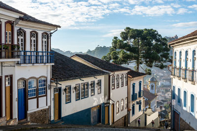 Buildings in town against sky