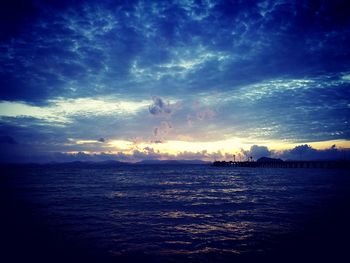 Scenic view of sea against cloudy sky