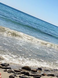Scenic view of beach against clear blue sky