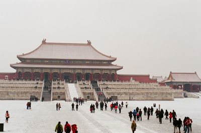 Group of people in temple against clear sky