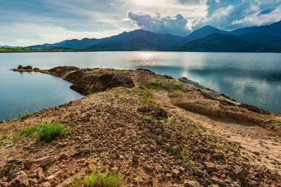 Scenic view of sea and mountains against sky