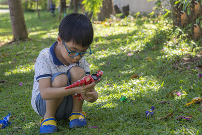 Full length of boy playing with toys on field