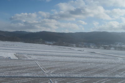 Scenic view of field against sky during winter