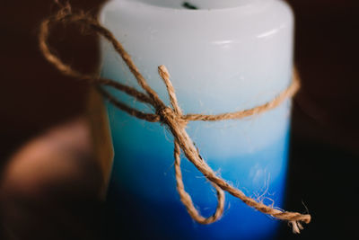 Close-up of rope tied to wooden post