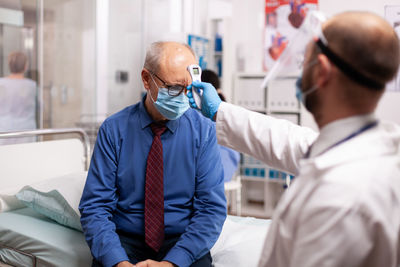 Side view of doctor examining patient at home