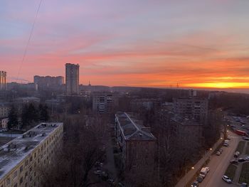 High angle view of buildings in city during sunset