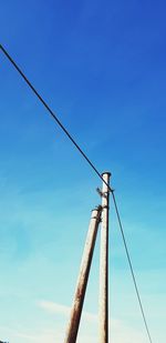 Low angle view of pole against blue sky