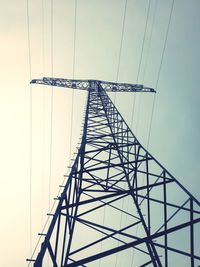 Low angle view of electricity pylon against clear sky