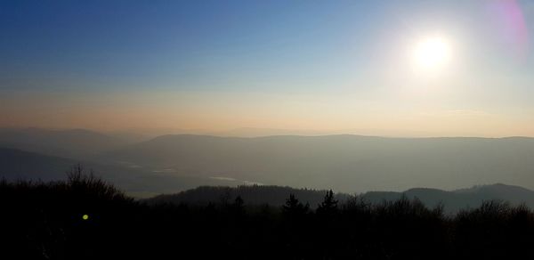 Scenic view of silhouette mountains against sky at sunset