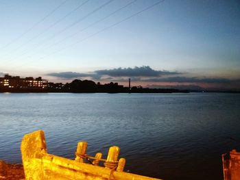 Scenic view of river against sky in city