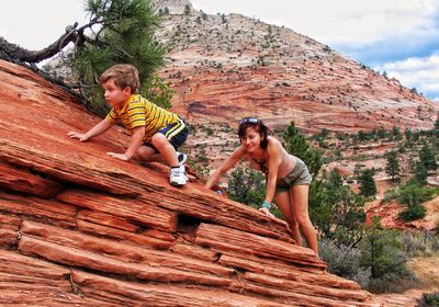 Child climbing on rock