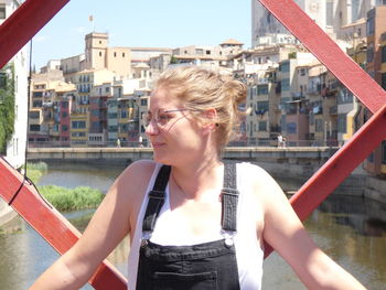 Portrait of woman against buildings in city