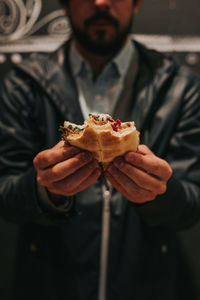 Midsection of man holding ice cream