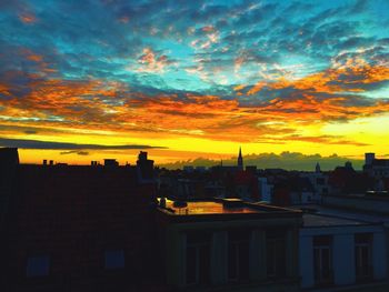 View of residential district against cloudy sky during sunset