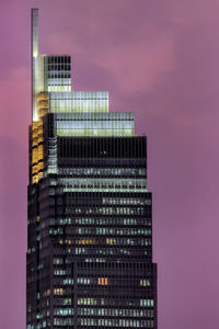 Low angle view of modern buildings against sky at night