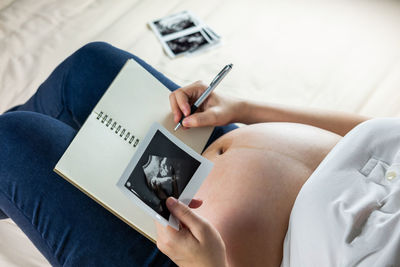 Midsection of woman using mobile phone
