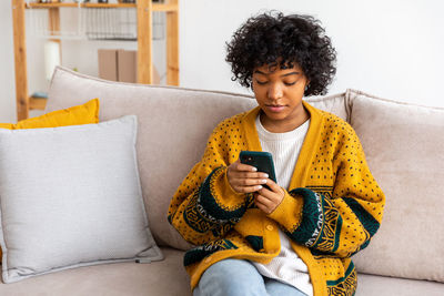 Portrait of young woman using mobile phone