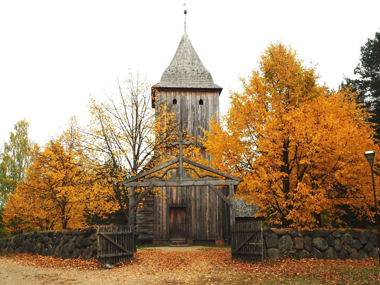 TRADITIONAL BUILDING BY TREES AGAINST CLEAR SKY