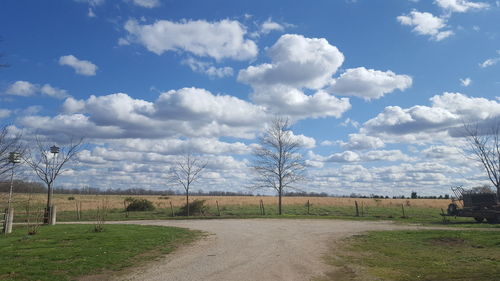 Scenic view of field against cloudy sky