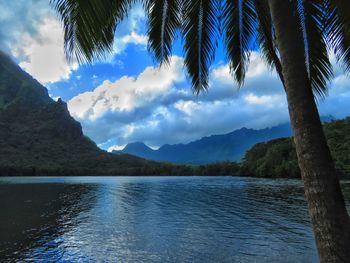 Scenic view of lake and mountains against blue sky