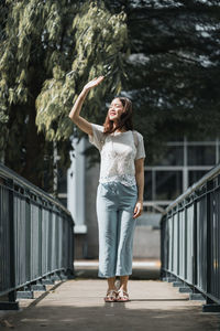 Full length of man standing on bridge