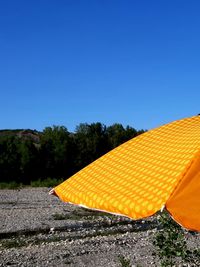 Scenic view of yellow and trees against clear blue sky