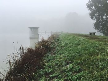 Scenic view of landscape against sky during foggy weather