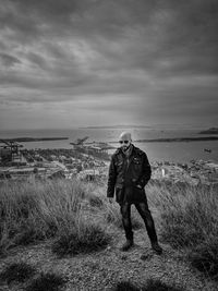 Full length of man standing on land against sky