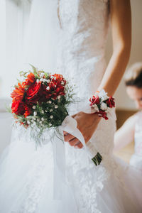 Close-up of woman holding bouquet of white flower