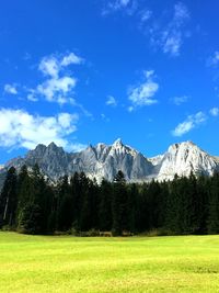 Scenic view of field and mountains against sky