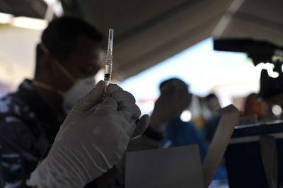 Rear view of people holding mobile phone