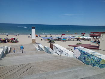 Scenic view of beach against clear blue sky