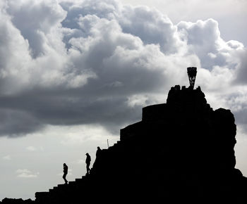 Low angle view of statue against cloudy sky