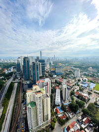 High angle view of modern buildings in city against sky