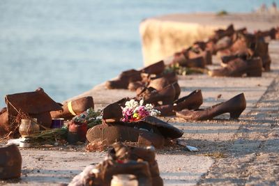 Close-up of shoes on beach