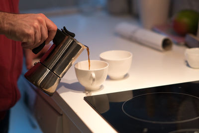 Wake up. pouring coffee from a moka pot