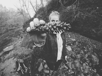 Woman standing on tree trunk