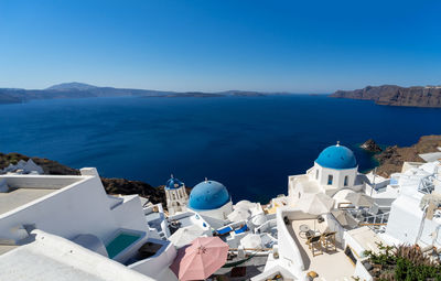 Beautiful panoramic view of santorini caldera with famous old blue domes of orthodox churches