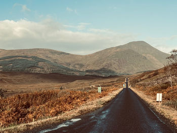 Road amidst mountains against sky