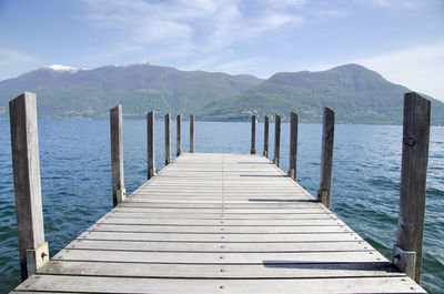 Pier on lake maggiore against mountains