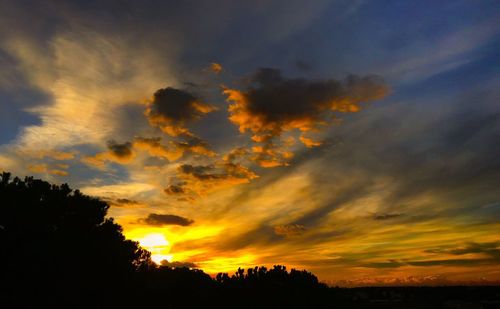 Low angle view of dramatic sky during sunset